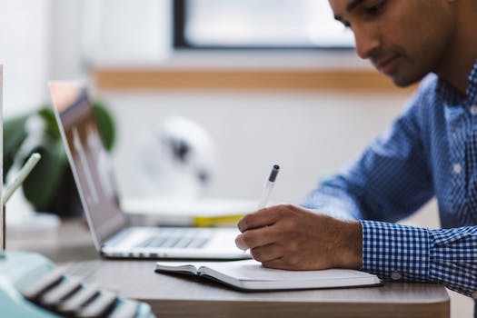 Photo of man using laptop