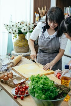 Woman making homemade noodles in kitchen