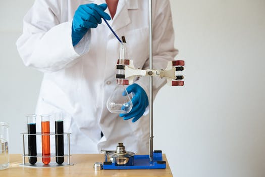 Faceless laboratory technician conducting chemical test