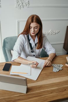 Photo of woman writing on a desk 