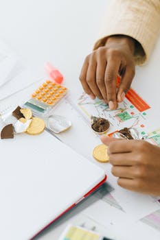 Person holding silver and gold chocolate coins