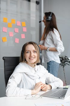 Woman in white long sleeve shirt working as a call center agent 