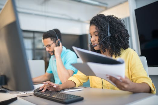 A man and woman working in the call center