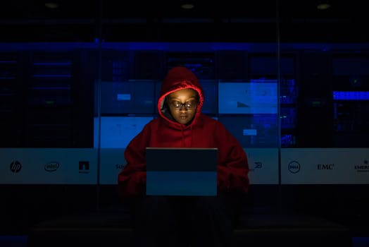 Woman wearing hooded pullover hoodie facing tablet computer