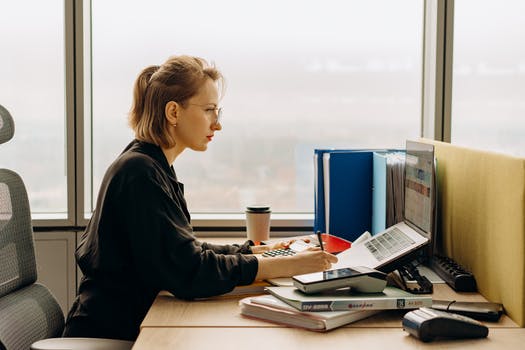 Woman using laptop sitting at the table