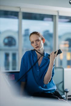 Female employee holding a telephone