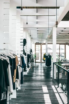 Fashion store interior with garments hanging on racks