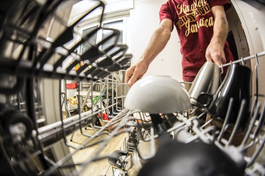 Fish eye photography of man pulling the dishwasher rack