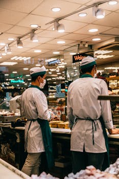 Sellers working at counter with different food