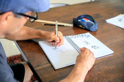 Man drawing in notebook