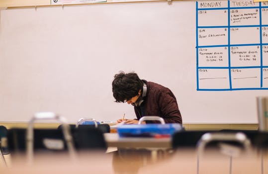 Man writing on table