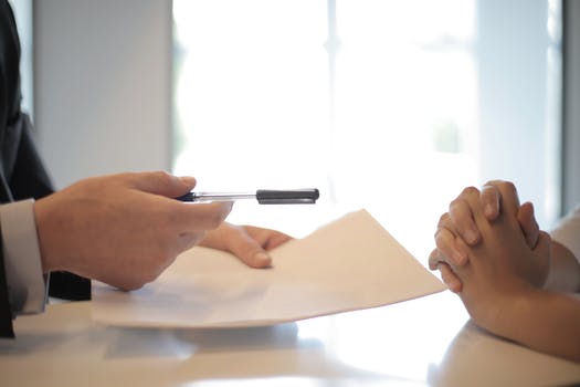 Crop businessman giving contract to woman to signcrop businessman giving contract to woman to sign