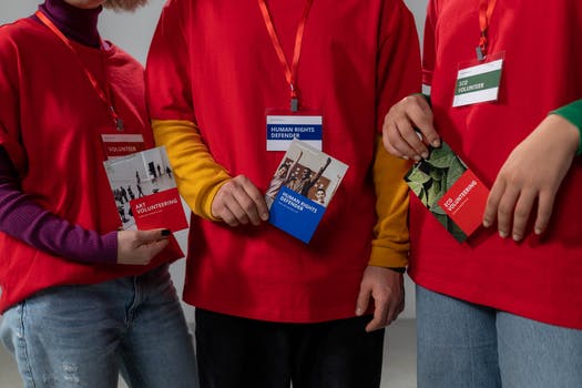 People holding red brochure