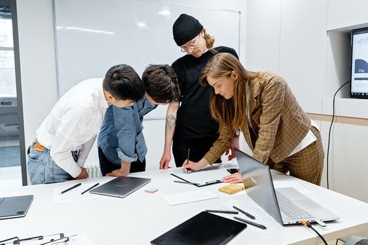 People standing around the table having a discussion