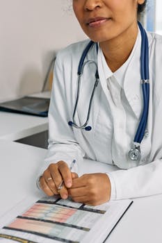 Person in white suit with blue stethoscope