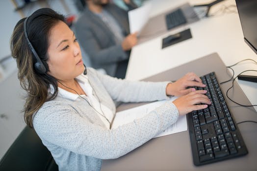 A woman typing on the keyboard