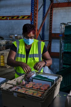 Portrait of woman packing food in box