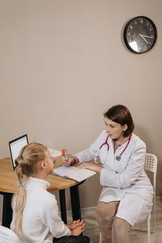 A doctor examining a child patient