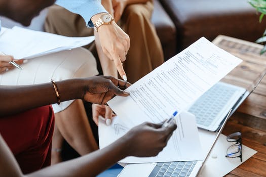  multiethnic businesswomen checking information in documents