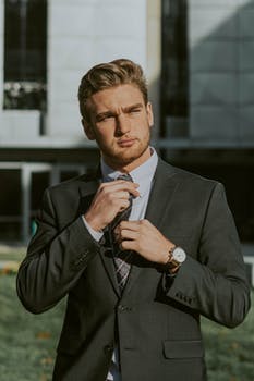 Elegant young bearded businessman in suit and tie in downtown