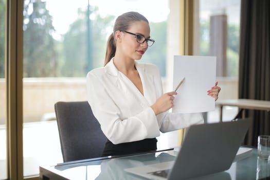 Confident businesswoman sharing information from documents in workplace 