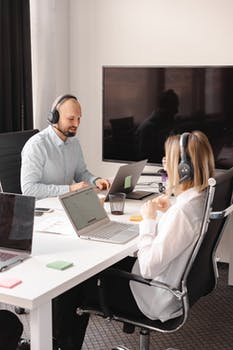 Man woman desk laptop