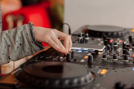 Dj playing music at mixing console