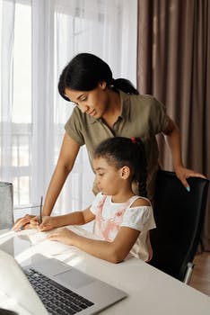 Mother helping her daughter with homework