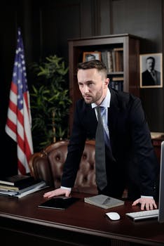 Businessman standing with his hands on his desk