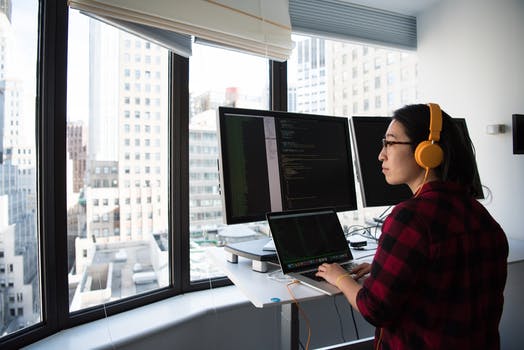 Woman sitting while operating macbook pro