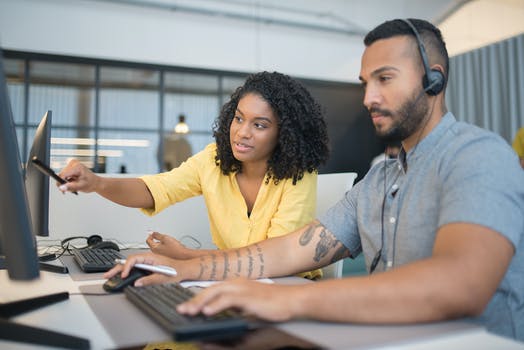 A man and woman working in the call center