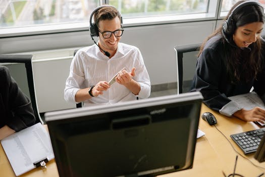 A man and woman working in the call center together