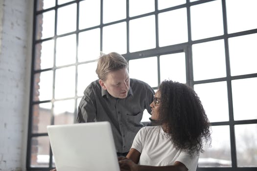 Focused multiracial coworkers of different age discussing business issues