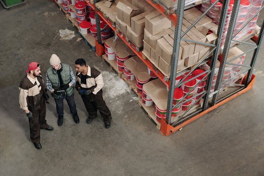 Men standing in a warehouse talking